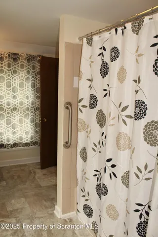 a view of bathroom with a shower curtain
