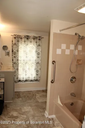 a bathroom with a bathtub and a shower