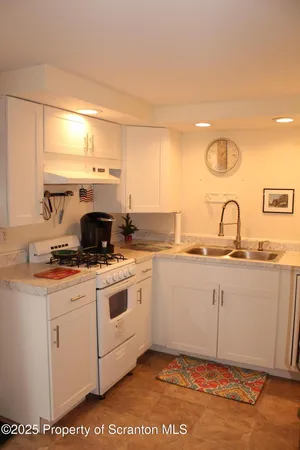 a kitchen with a sink cabinets and appliances