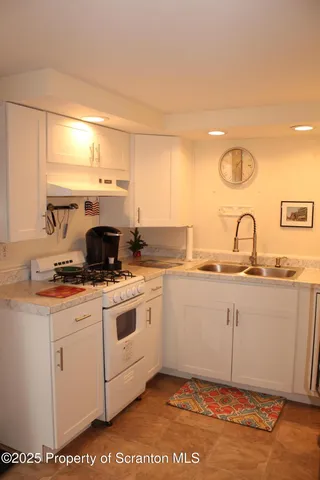 a kitchen with a sink cabinets and appliances