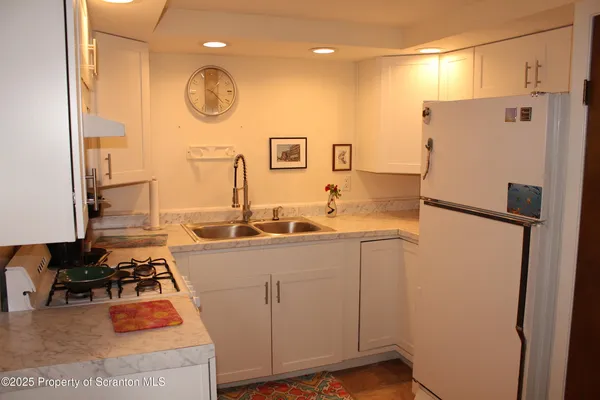 a kitchen with a refrigerator and a stove