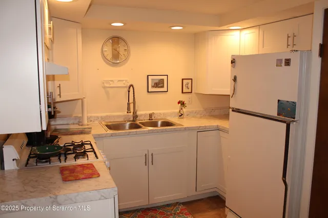 a kitchen with a refrigerator and a stove