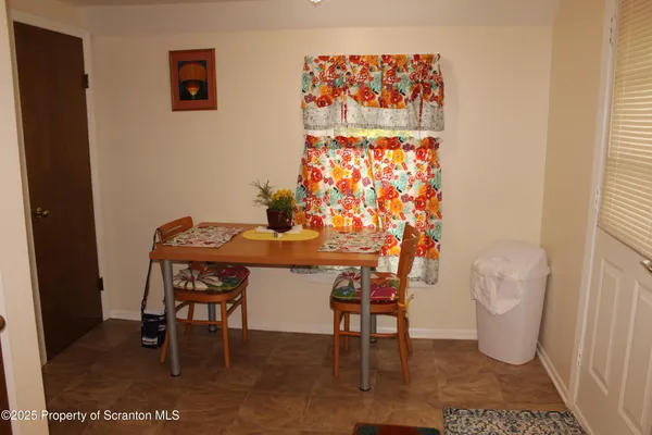 a dining room with furniture and a rug