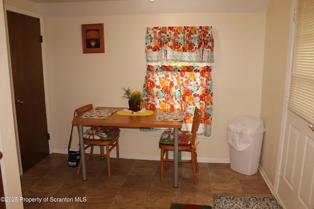 a dining room with furniture and a rug
