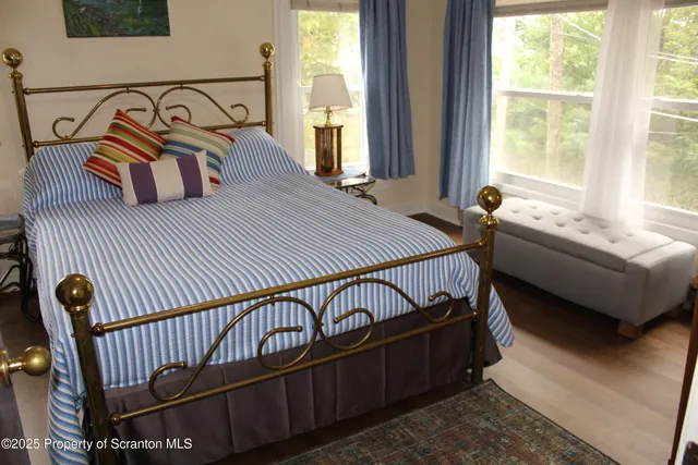 a bedroom with bed and a window