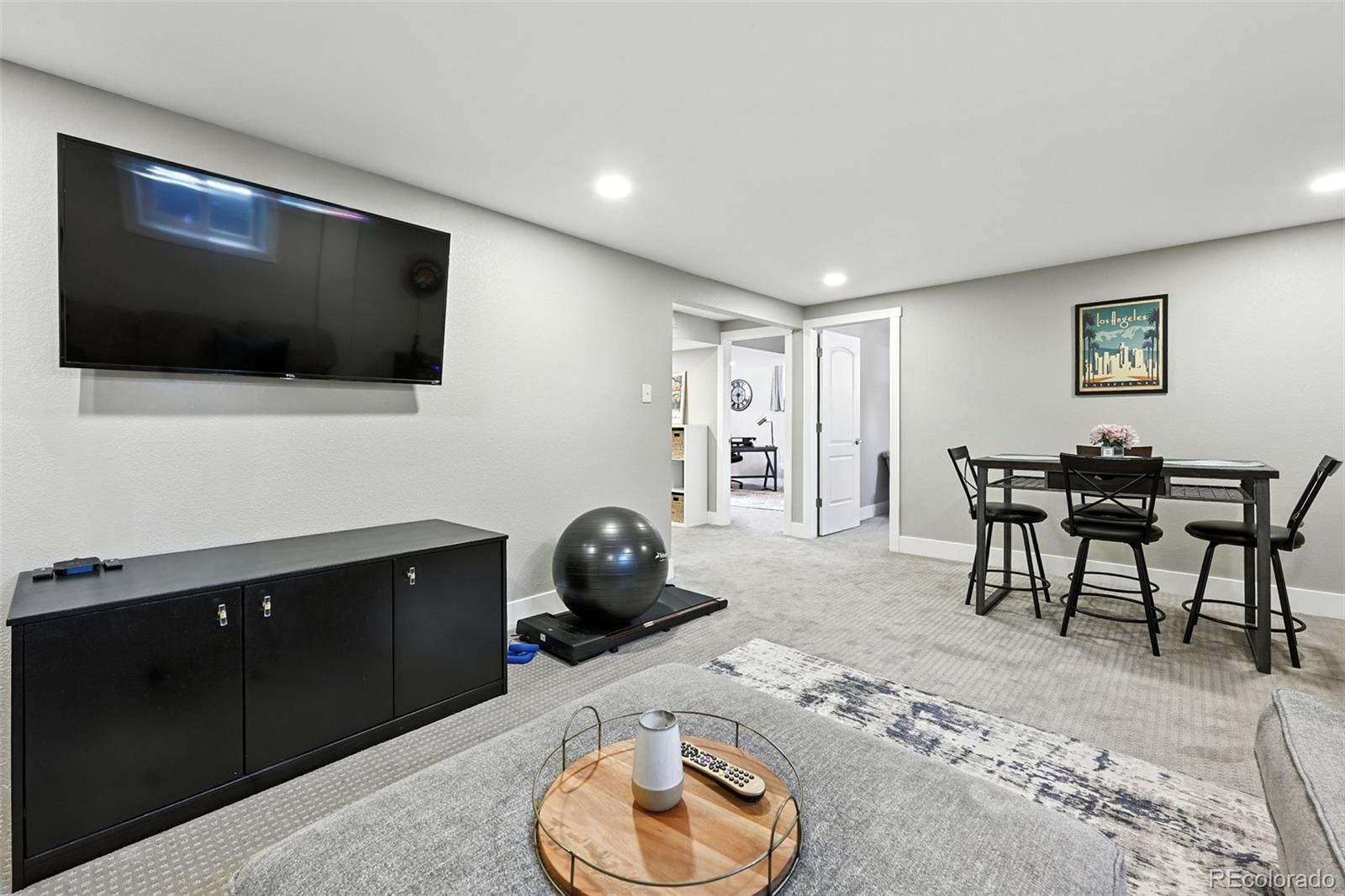 2714 South Raleigh Street Denver, CO 80236 - Photo 20 of 34 a living room with furniture and a flat screen tv
