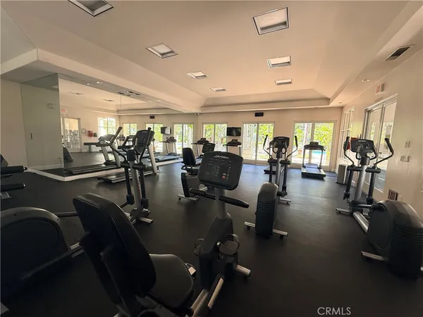 a view of a livingroom with furniture and a gym machine