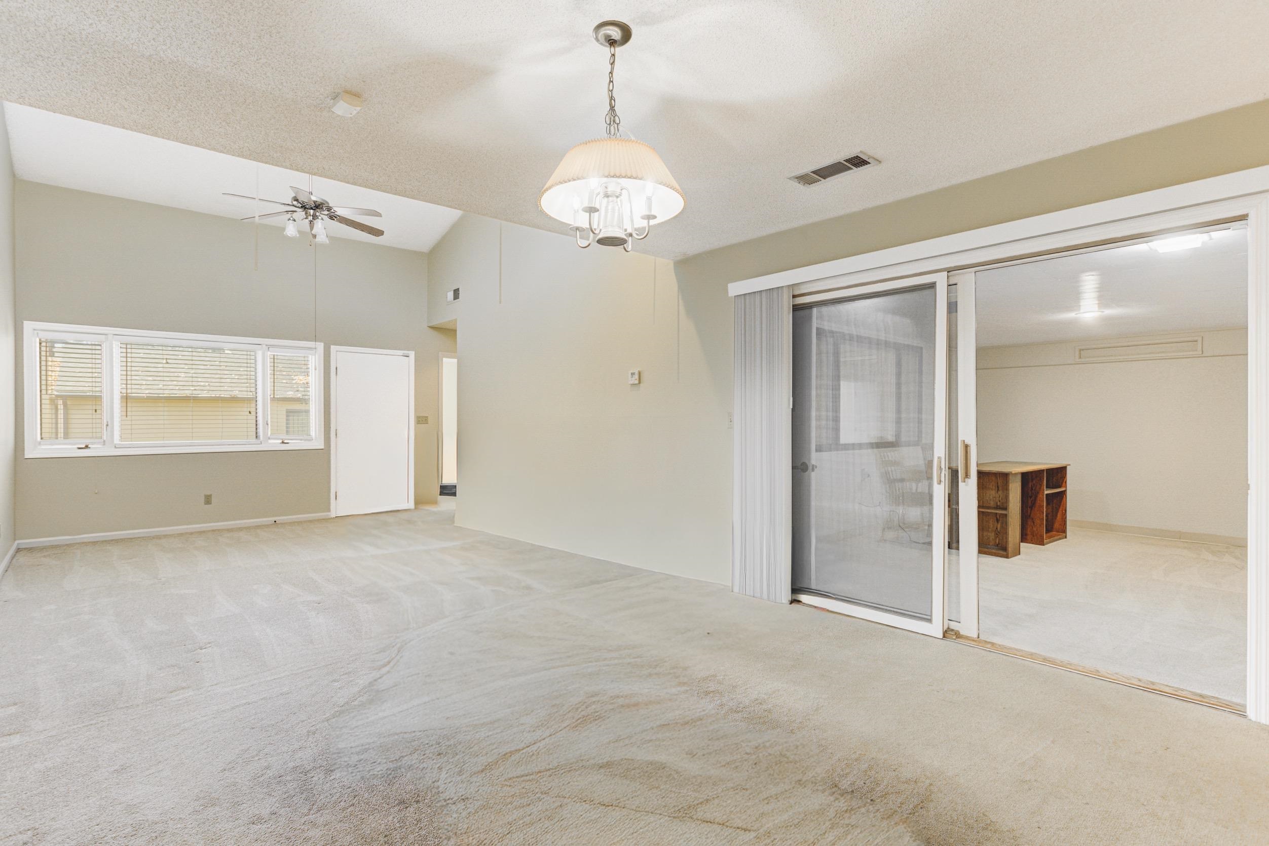 5013 Scheibler Road, Unit C1 Memphis, TN 38128 - Photo 9 of 36 Unfurnished room featuring light colored carpet, a textured ceiling, vaulted ceiling, and a ceiling fan