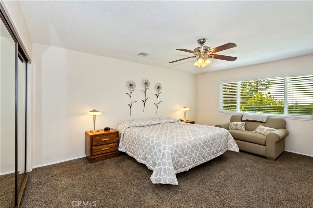 8527 Hillside Road Rancho Cucamonga, CA 91701 - Photo 26 of 50 a spacious bedroom with a bed and a chandelier