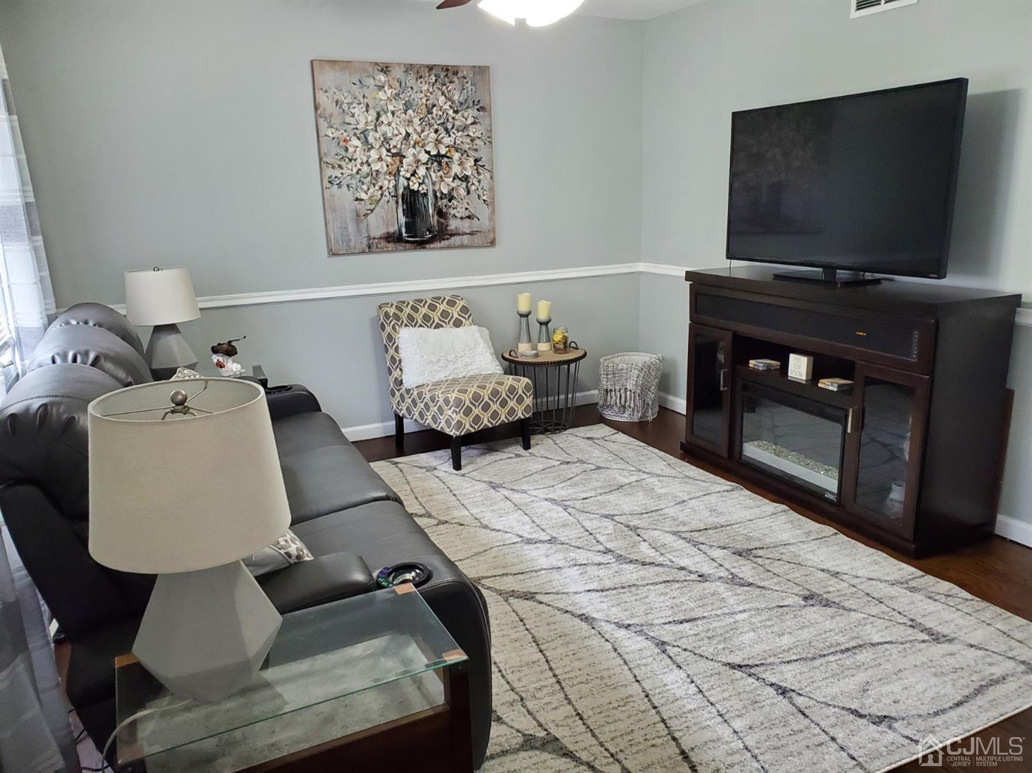 12 Bowser Road New Brunswick, NJ 08901 - Photo 3 of 21 a living room with furniture and a flat screen tv