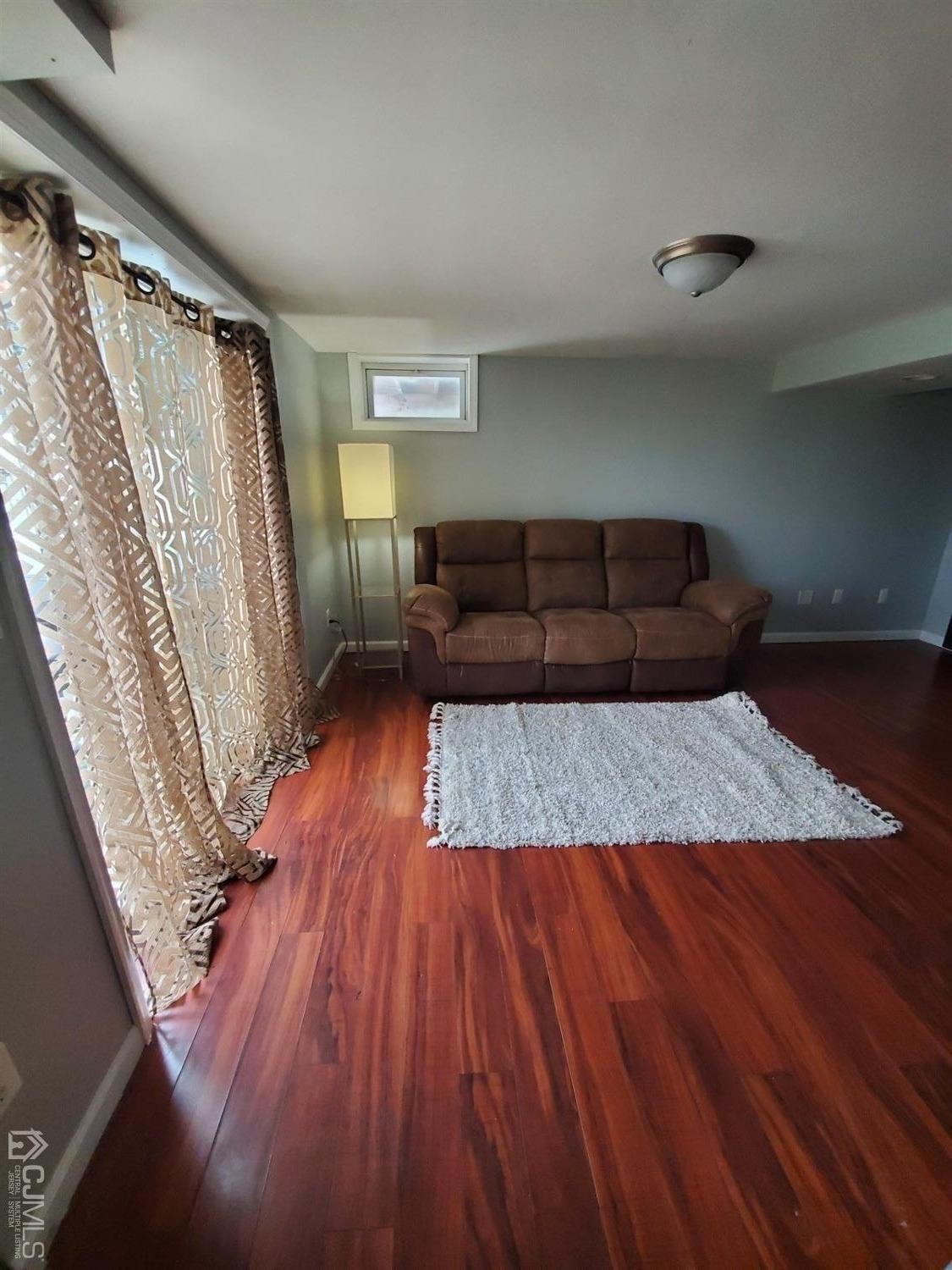 12 Bowser Road New Brunswick, NJ 08901 - Photo 10 of 21 a living room with a bed furniture and a wooden floor