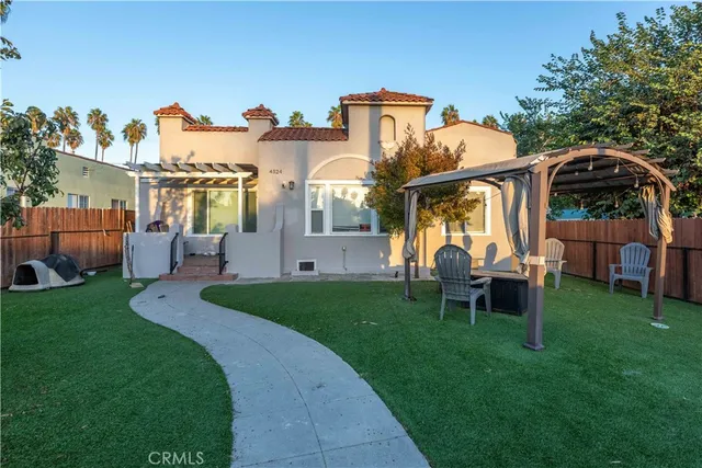 a front view of house with a garden and patio