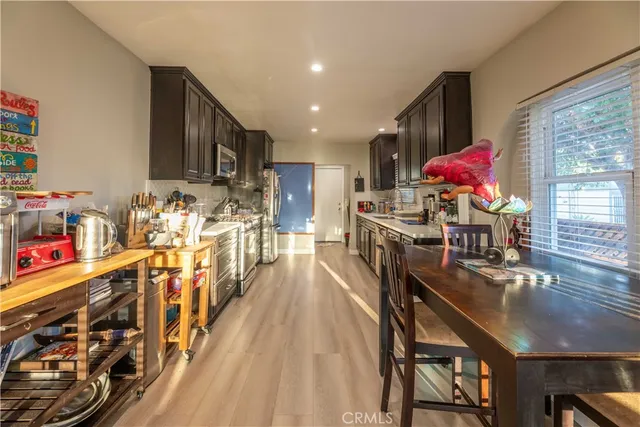 a dining room filled with furniture and wooden floor