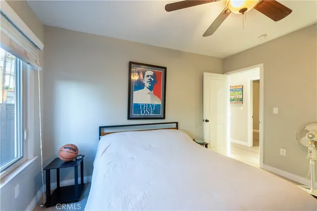 a bedroom with a bed and a painting on the wall