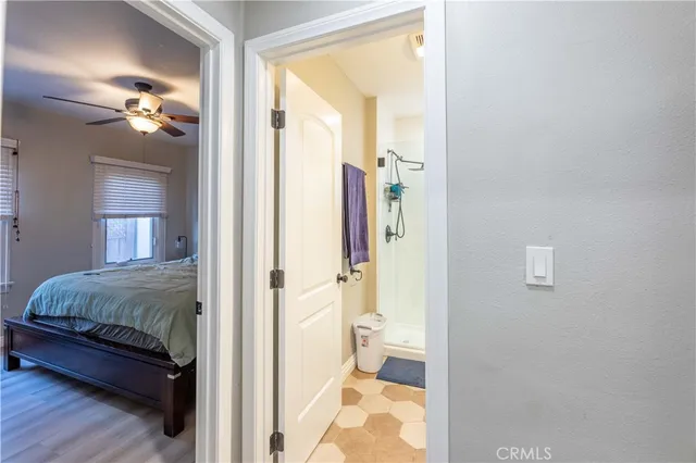 a en suite bathroom with a granite countertop sink and a mirror