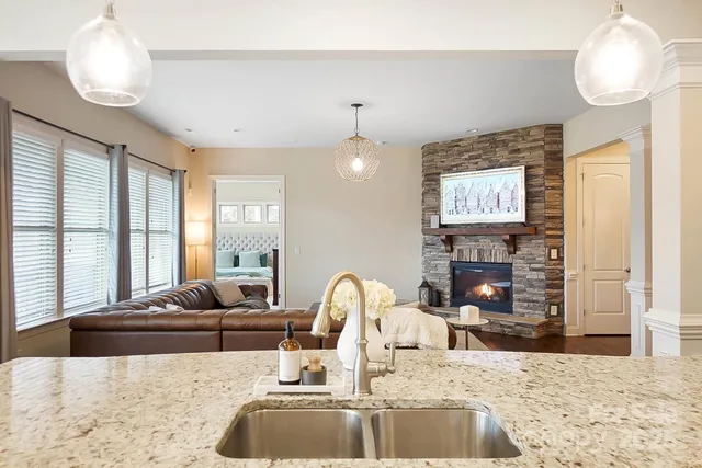 a living room with fireplace furniture and a large window
