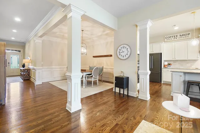 a livingroom with furniture wooden floor and a clock