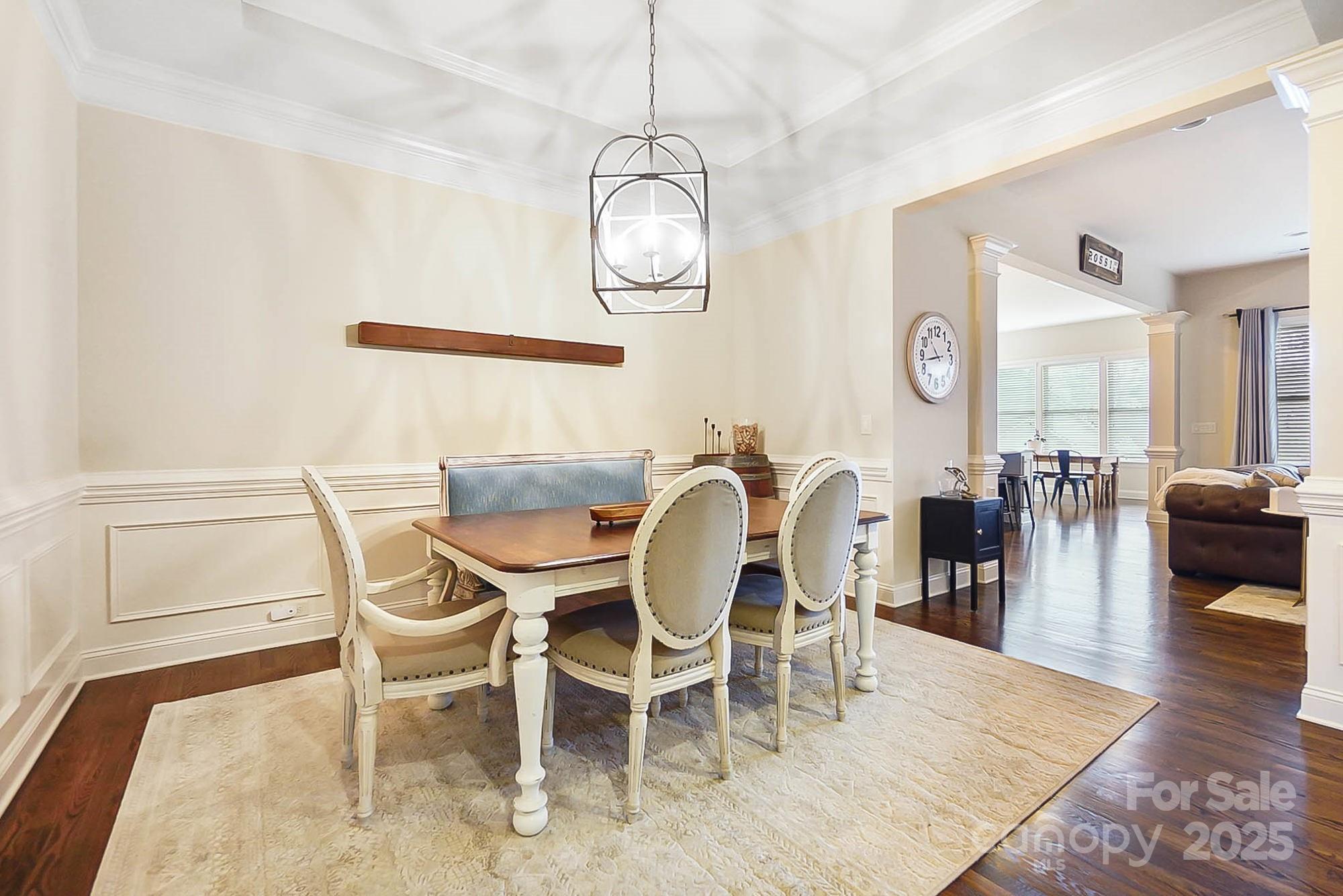 1419 Vickery Drive Matthews, NC 28104 - Photo 15 of 48 a dining room with wooden floor a glass table and chairs