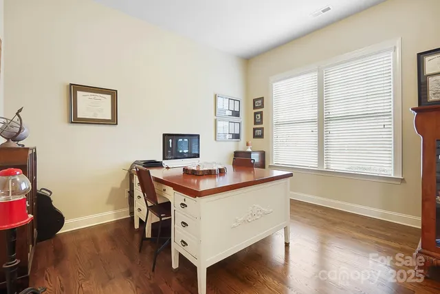 a view of a workspace with furniture and a window