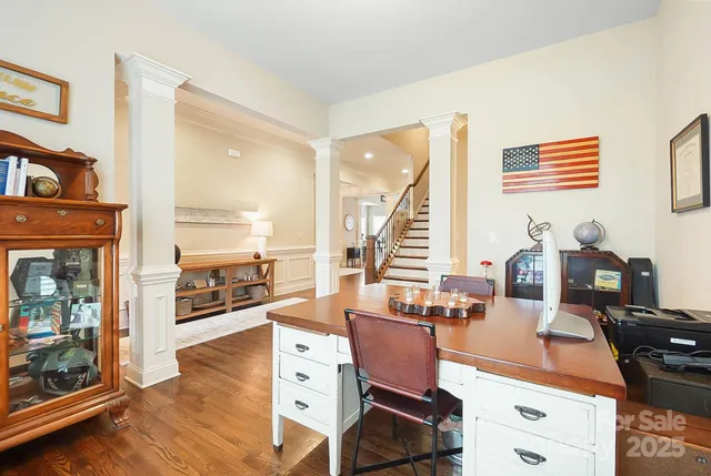 a living room with fireplace furniture and a floor to ceiling window