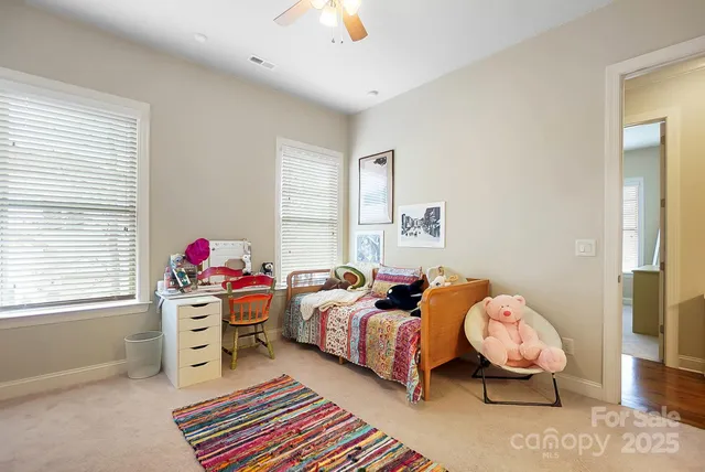 a bedroom with two beds and a window