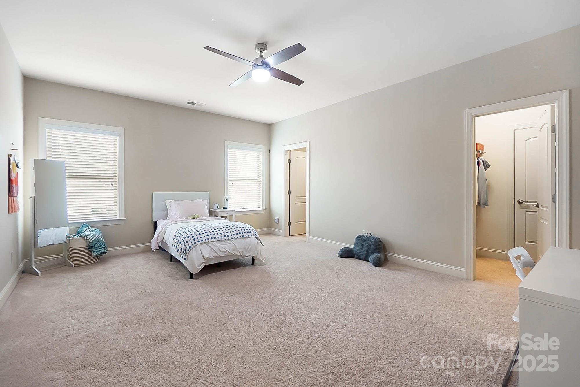 1419 Vickery Drive Matthews, NC 28104 - Photo 33 of 48 a bedroom with a bed and a chandelier