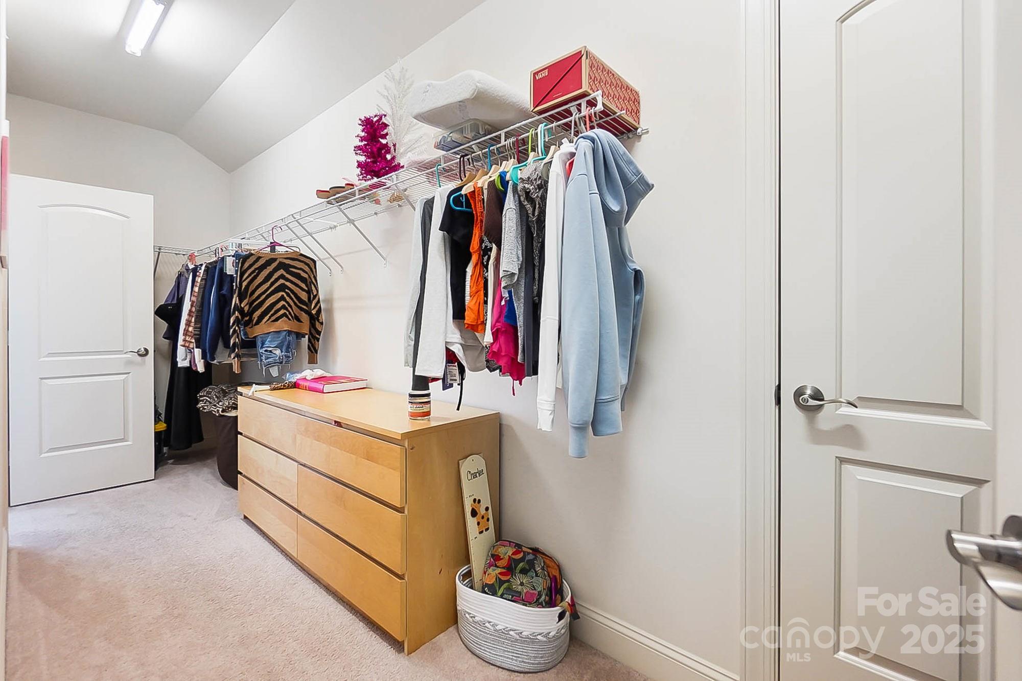 1419 Vickery Drive Matthews, NC 28104 - Photo 35 of 48 a view of walk in closet with clothes and shoes