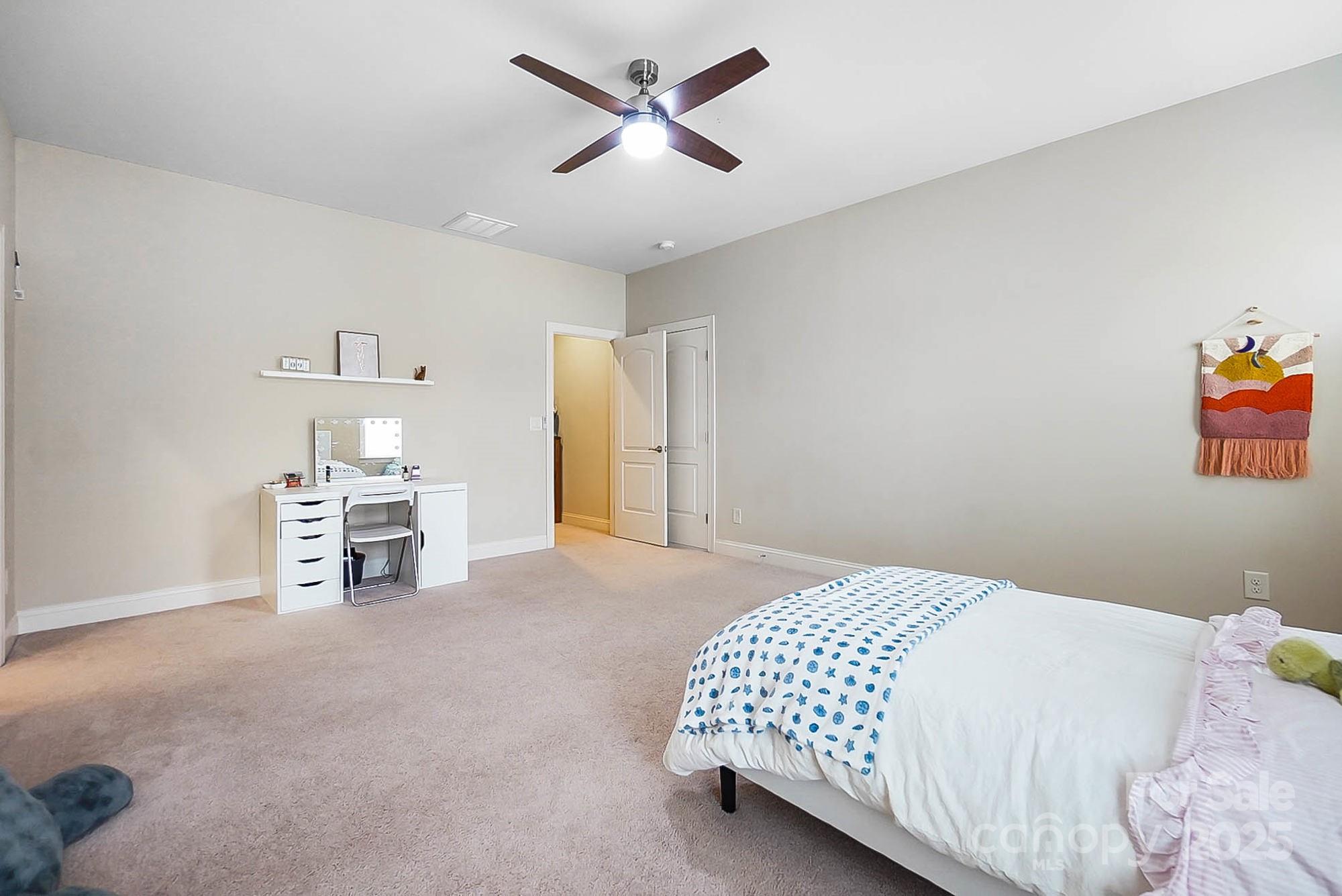 1419 Vickery Drive Matthews, NC 28104 - Photo 36 of 48 a bedroom with a bed and a chandelier