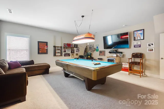 a living room with furniture a window and a flat screen tv