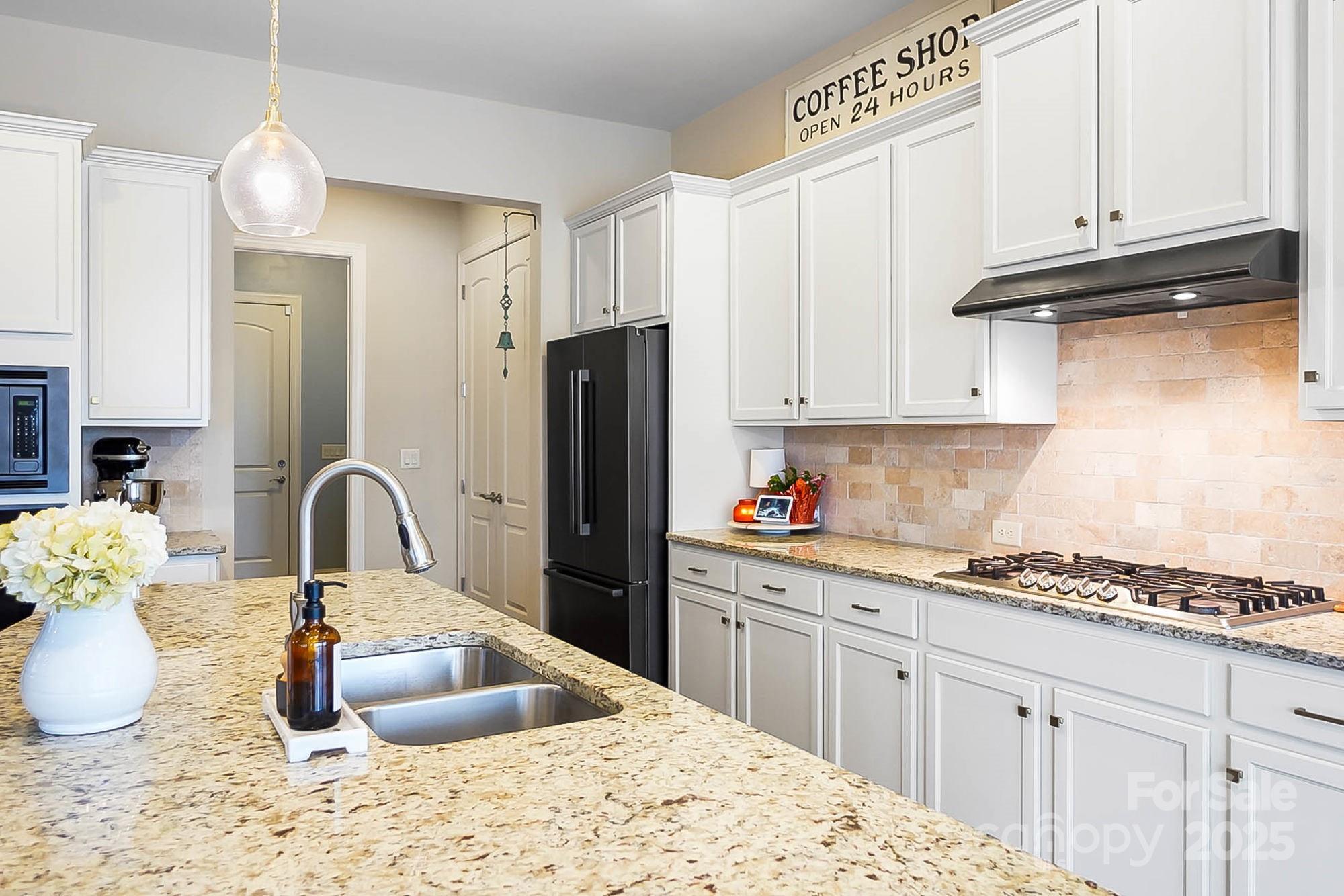 1419 Vickery Drive Matthews, NC 28104 - Photo 10 of 48 a kitchen with stainless steel appliances granite countertop a refrigerator and a stove top oven