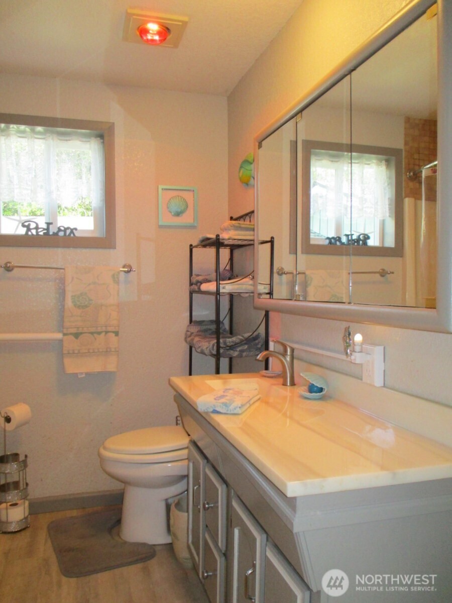369 North Razor Clam Drive Southwest Ocean Shores, WA 98569 - Photo 19 of 27 a bathroom with a sink a toilet and mirror