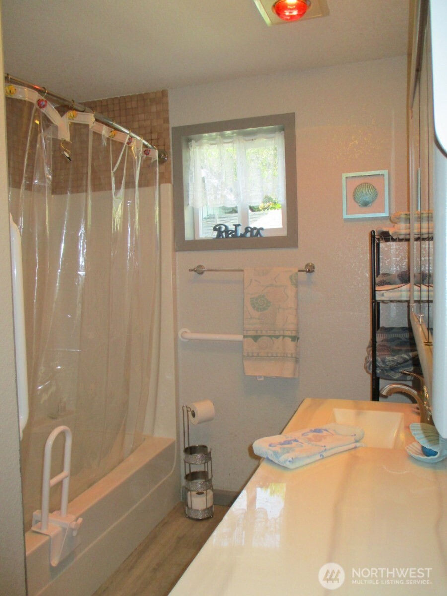 369 North Razor Clam Drive Southwest Ocean Shores, WA 98569 - Photo 20 of 27 a bathroom with a sink and a mirror