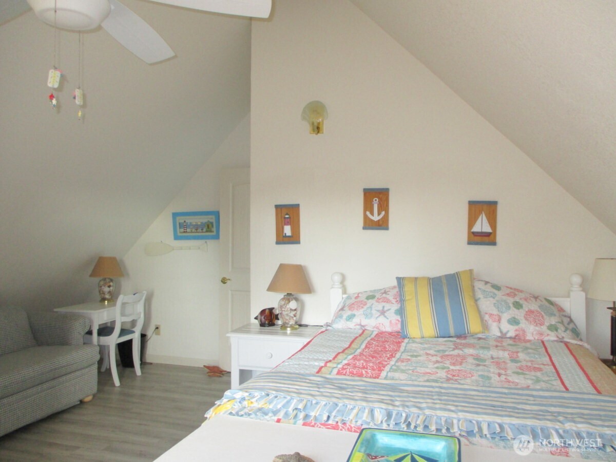 369 North Razor Clam Drive Southwest Ocean Shores, WA 98569 - Photo 22 of 27 a bedroom with a bed and wooden floor