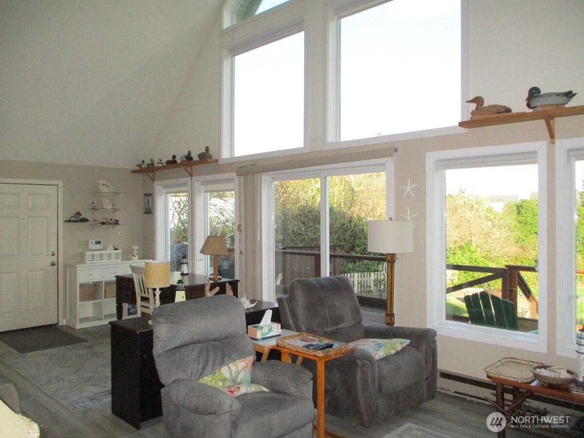 369 North Razor Clam Drive Southwest Ocean Shores, WA 98569 - Photo 7 of 27 a living room with furniture and large windows