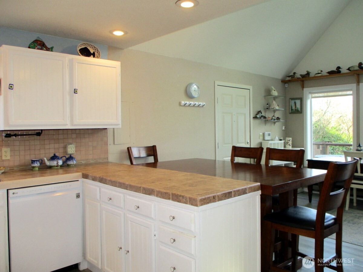 369 North Razor Clam Drive Southwest Ocean Shores, WA 98569 - Photo 9 of 27 a kitchen with a stove a table and chairs