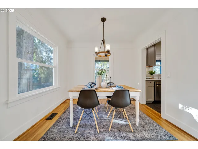 a kitchen with white cabinets and sink