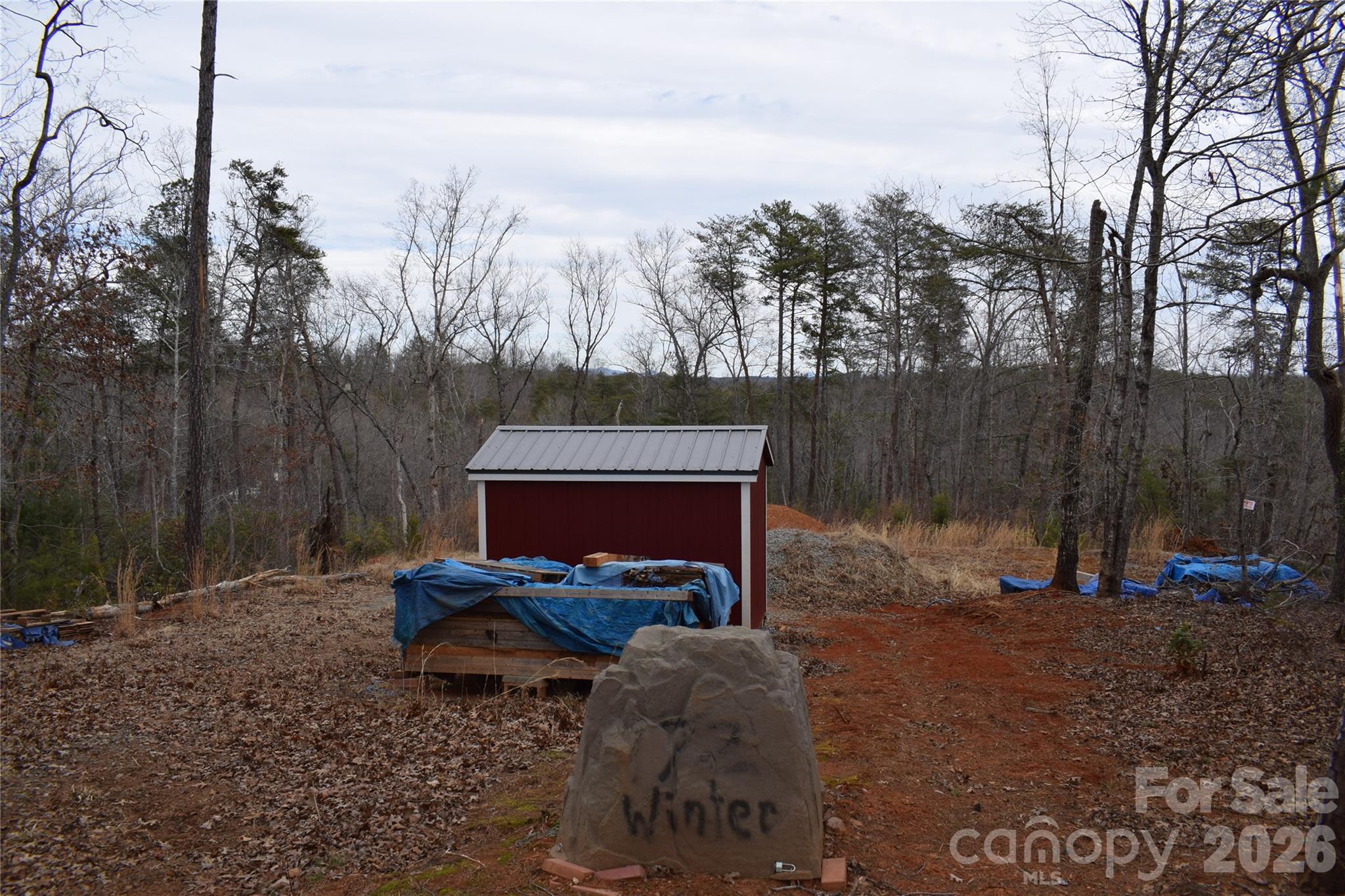 172 Winter Lane Mill Spring, NC 28756 - Photo 5 of 20 a backyard of a house with table and chairs