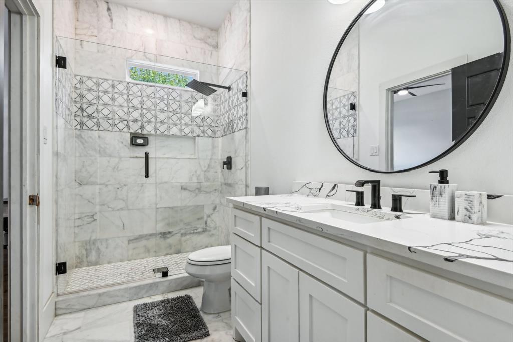 478 Polly Road Sunnyvale, TX 75182 - Photo 30 of 40 Full bathroom with marble finish floors, vanity, and a shower stall