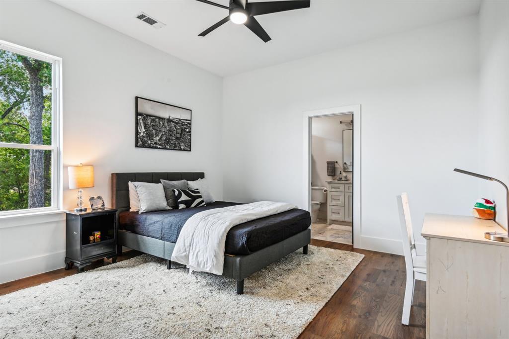 478 Polly Road Sunnyvale, TX 75182 - Photo 32 of 40 Bedroom featuring multiple windows, dark wood-style flooring, and ensuite bath