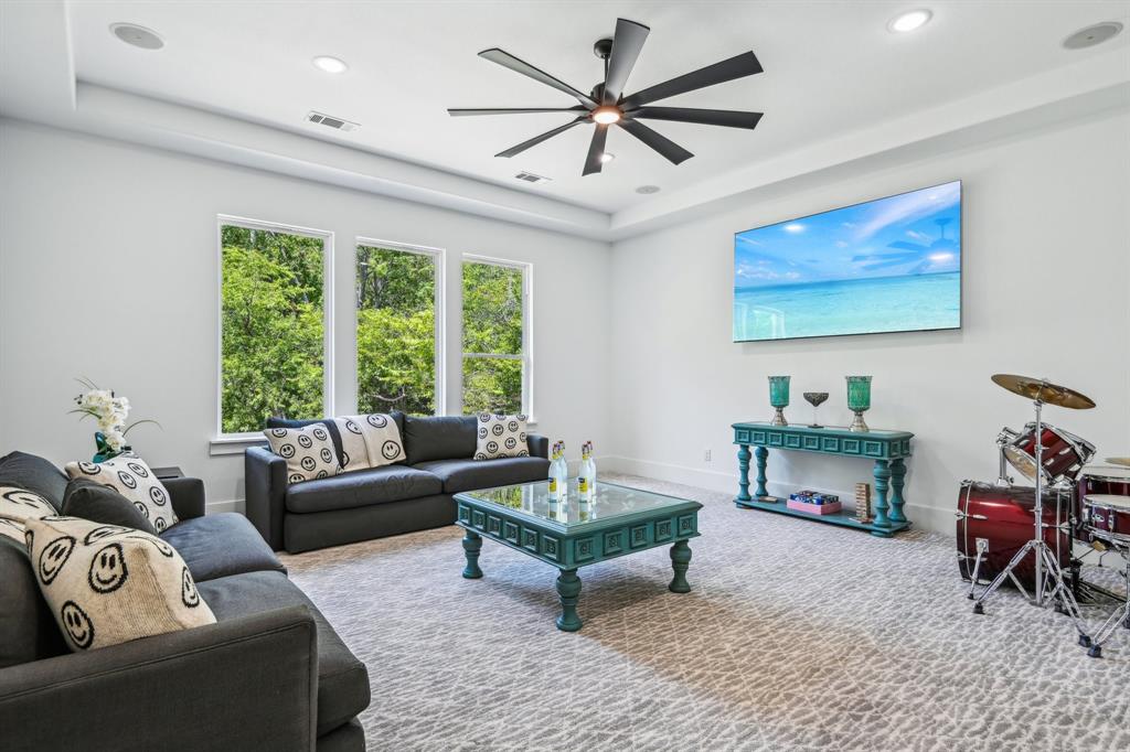 478 Polly Road Sunnyvale, TX 75182 - Photo 34 of 40 Carpeted living room featuring a ceiling fan, recessed lighting, and a tray ceiling