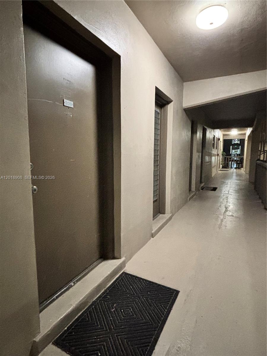 1480 East Sample Road, Unit 209 Pompano Beach, FL 33064 - Photo 5 of 24 a view of a hallway with wooden floor