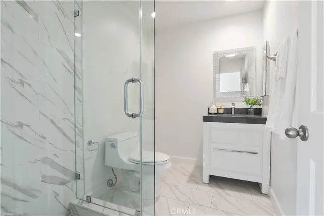 a bathroom with a shower and toilet