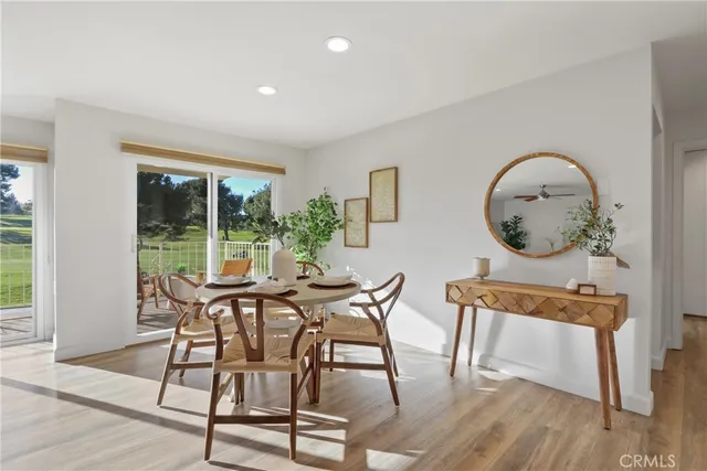 a view of a dining room with furniture window and wooden floor
