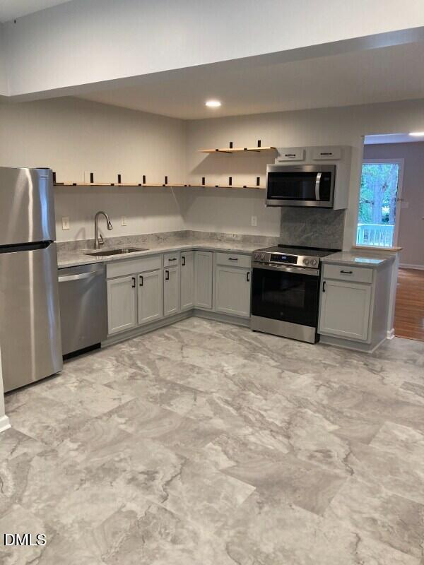 1505 Woodland Road Garner, NC 27529 - Photo 2 of 19 a kitchen with stainless steel appliances granite countertop a stove a sink and a refrigerator