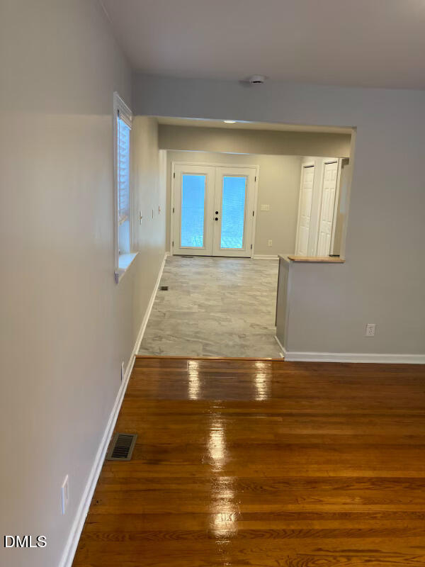 1505 Woodland Road Garner, NC 27529 - Photo 5 of 19 a view of an empty room with wooden floor