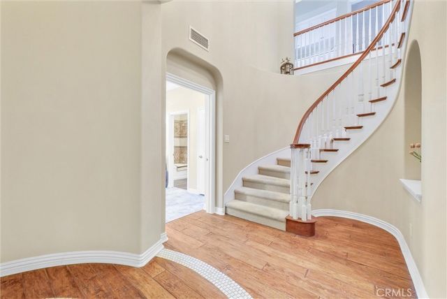 a dining hall with stainless steel appliances kitchen island granite countertop a table and chairs in it