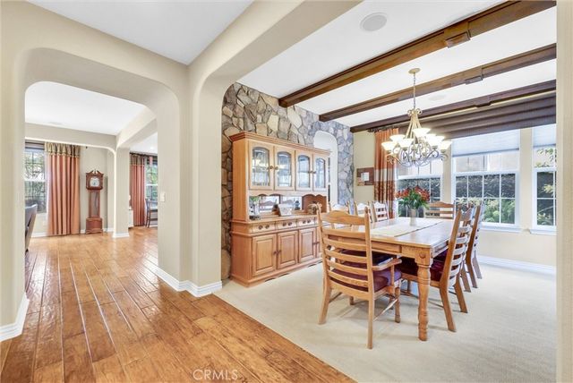 a room with lots of wooden furniture and a chandelier