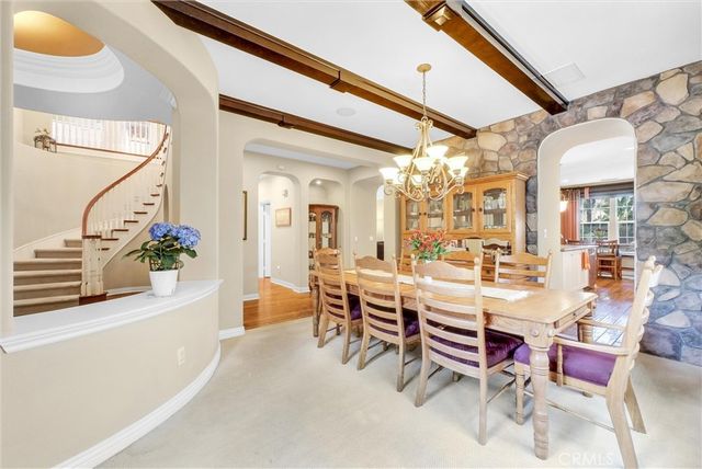 a dining room with furniture a chandelier and a rug