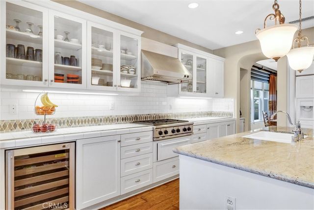 a large kitchen with kitchen island a large counter space a sink appliances and living room view