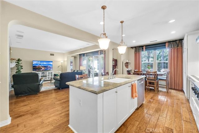 a kitchen with a stove a window and chairs